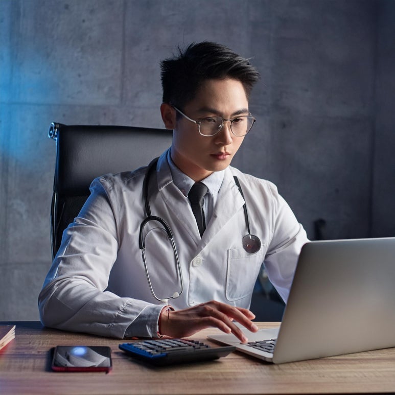 Firefly A medical professional calculating the word count on laptop monitor 