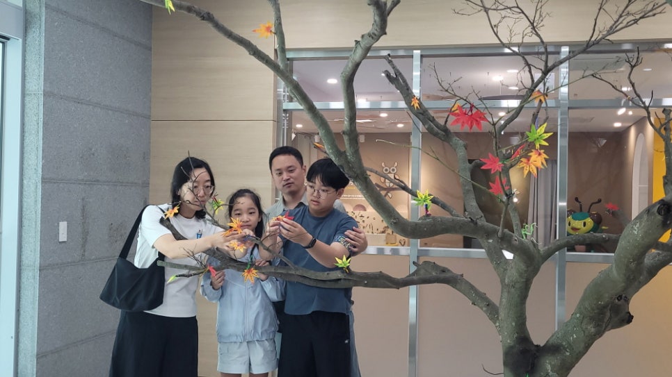 Another family hanging wish leaves at the Naejangsan visitor centre.