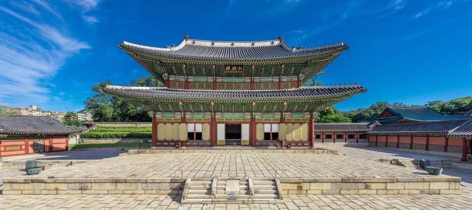 Changdeokgung Palace: the tiled roofs around Injeongjeon hall against wooded hills