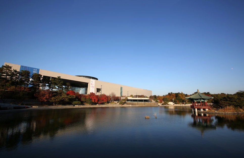 The Mirror Pond at the National Museum of Korea in autumn colour, with the Cheongjajeong pavilion standing over the water
