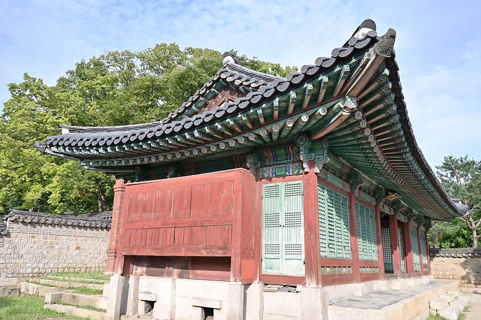 성정각 일원 전각의 측면. 붉은 판장과 녹색 창호, 단청을 올린 처마를 낮은 각도에서 담았다