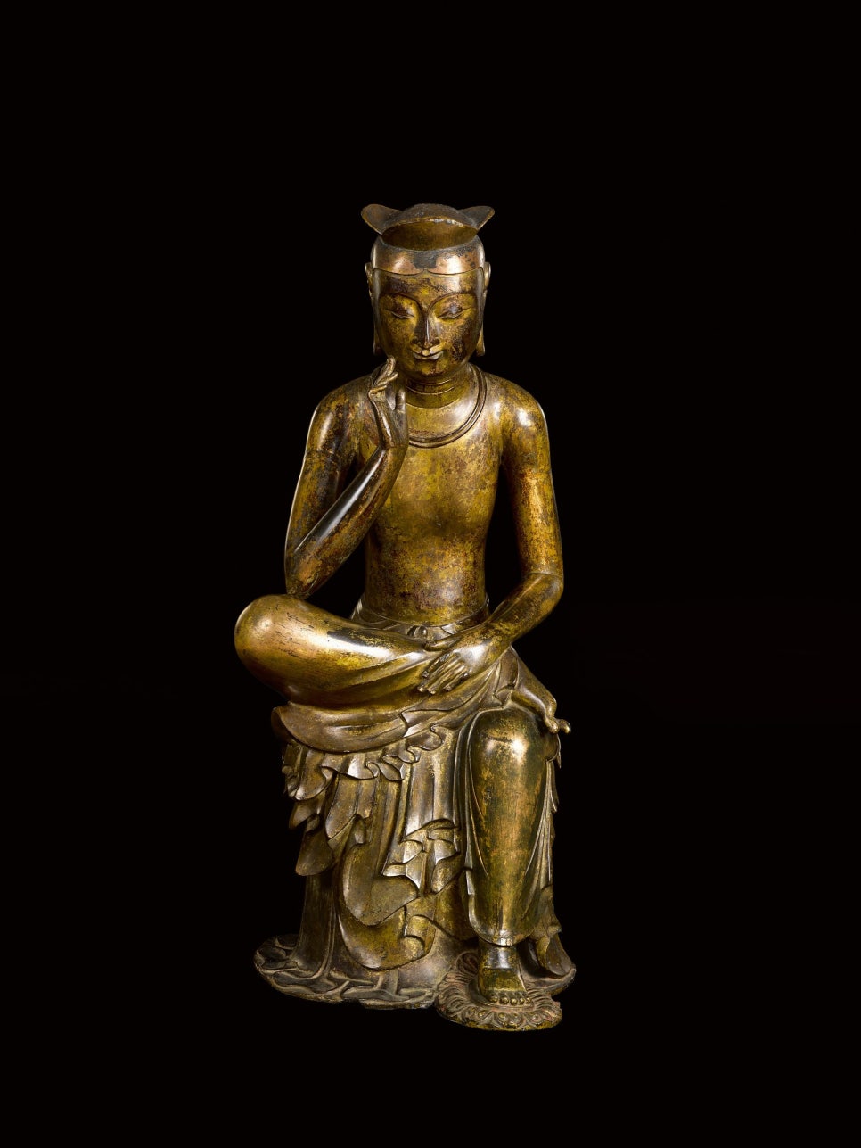 Another gilt-bronze pensive bodhisattva, wearing a three-panelled crown and smiling.