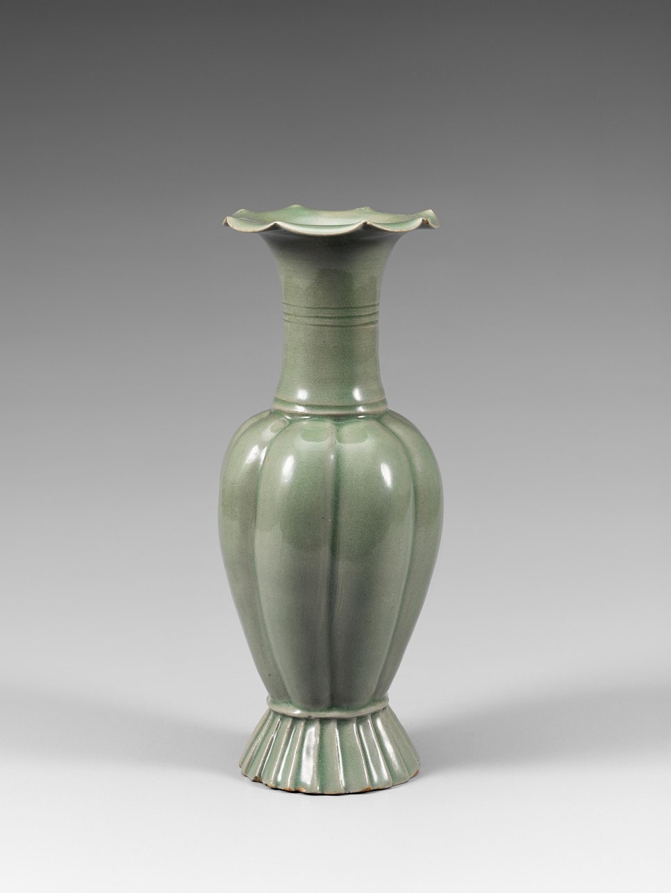 A Goryeo celadon bottle with a melon-shaped body and a fluted foot.
