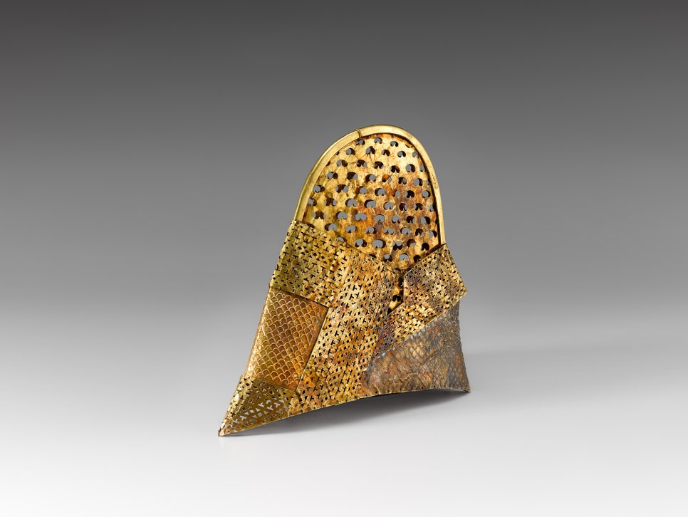 A conical Silla cap made from cut and joined sheet gold, its whole surface pierced with small openwork motifs