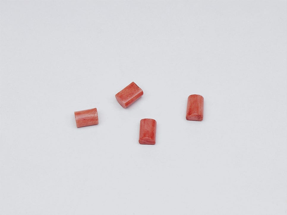 A close view of four tiny reddish yut sticks