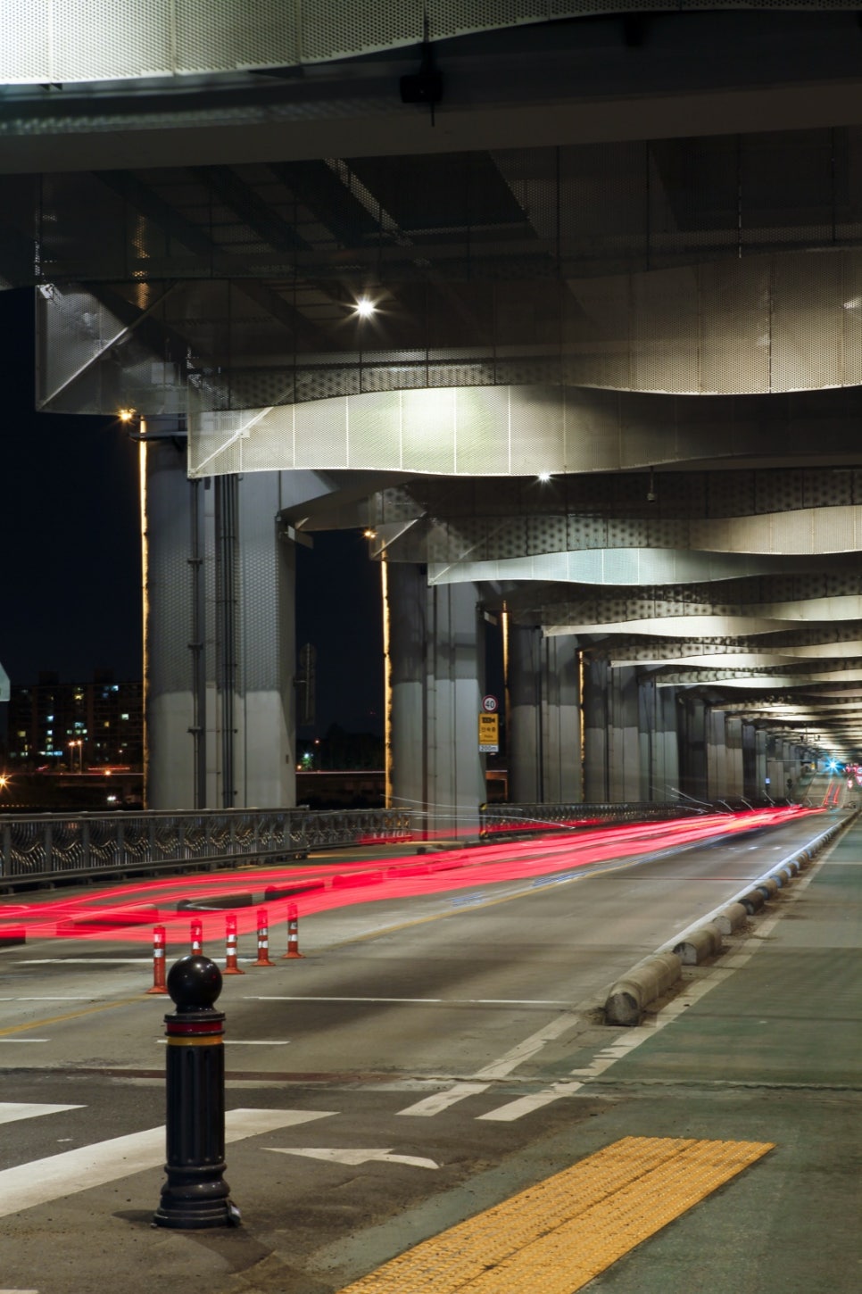 Portrait view of the Jamsugyo roadway running straight beneath Banpo Bridge, open to traffic