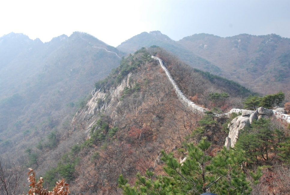 Fortress walls running along a Bukhansan ridge in autumn light