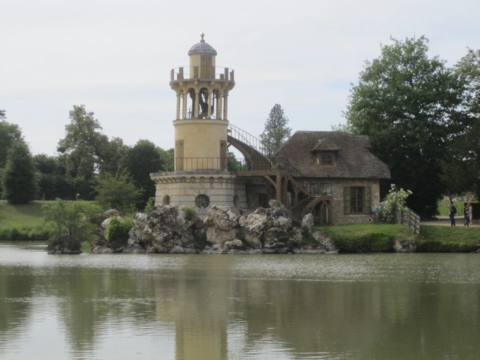 Thatched cottages by a pond in the Queen's Hamlet at Versailles