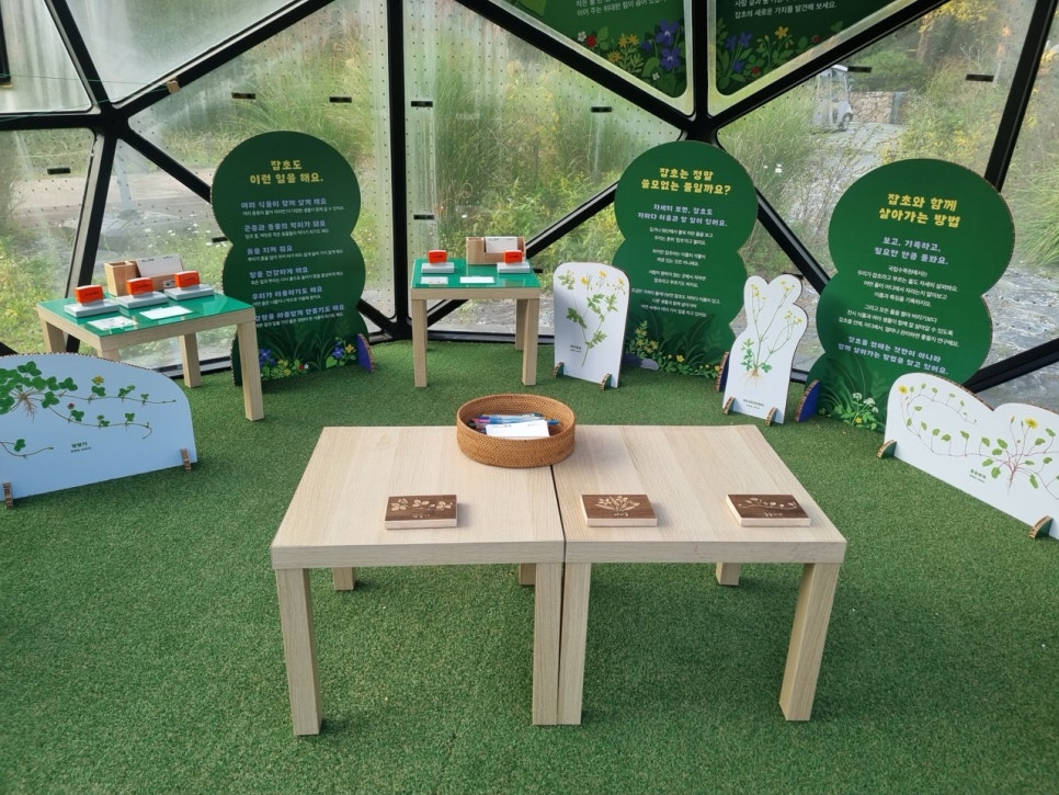 A rubbing table with woodblocks and paper, with an information panel behind