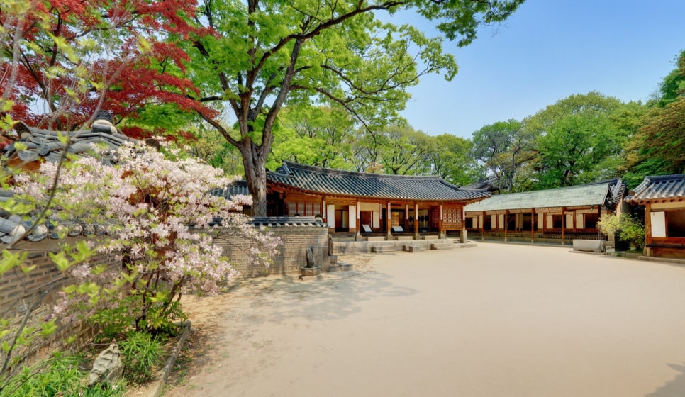 Yeongyeongdang's men's quarters with azaleas and fresh spring leaves