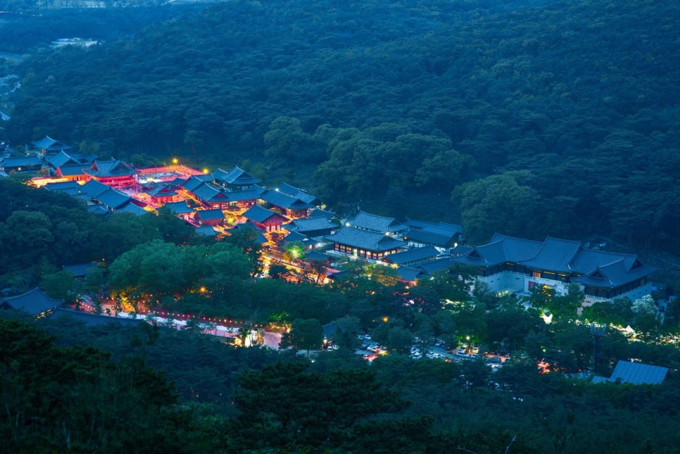 Night view looking down over the lit halls and courtyards of Tongdosa Temple in Yangsan