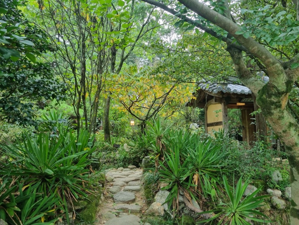 Stone steps through a bamboo grove leading to a hanok gate at Ssangsanjae in Gurye