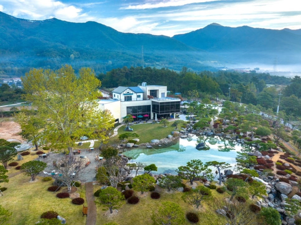 A pond and pine garden at Banyawon in Gurye, with the Jirisan ridges behind