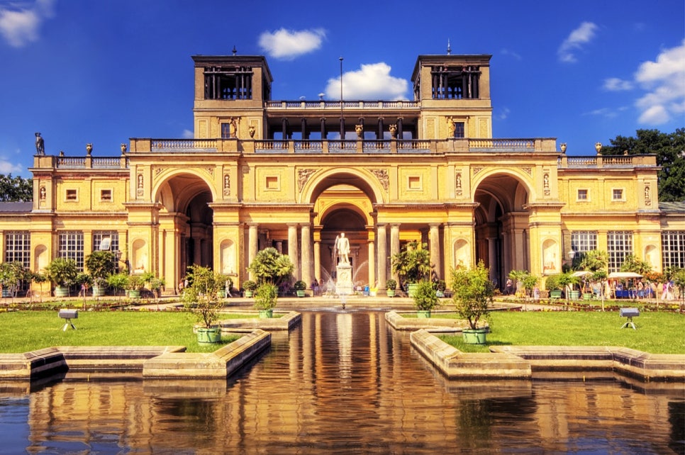 The Orangery Palace in Sanssouci Park, Potsdam, with its towers on a hill above terraced gardens