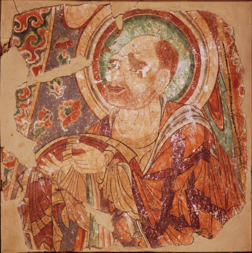 Mural fragment of a monk in profile holding an offering