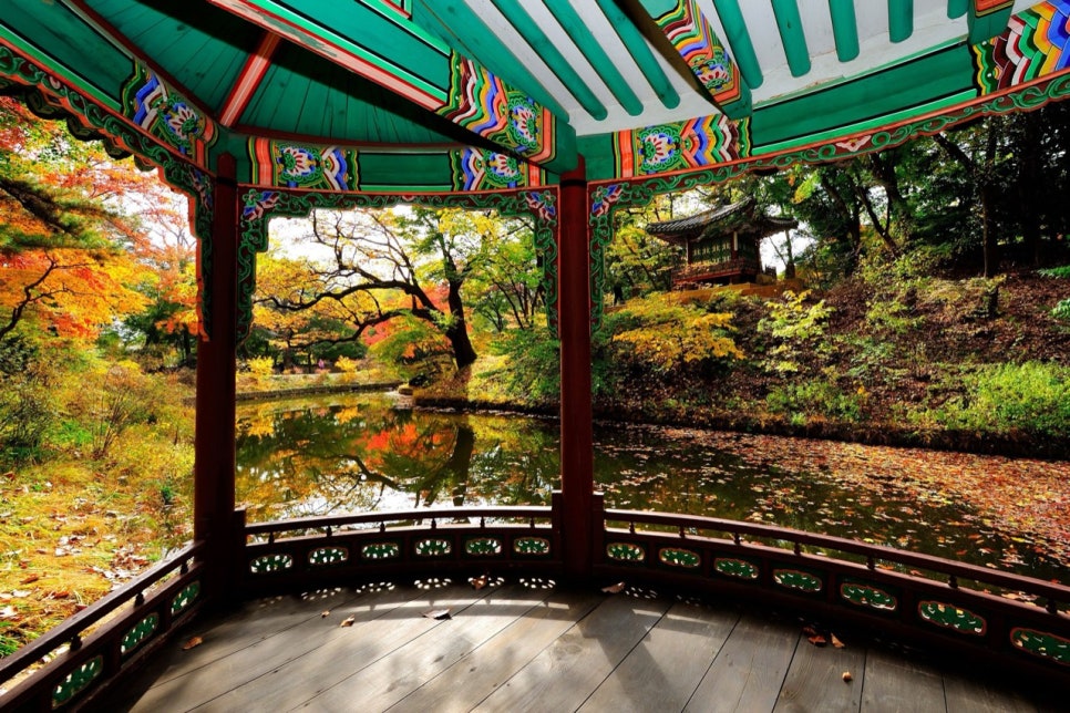 White Great Greenhouse of Changgyeonggung surrounded by autumn leaves