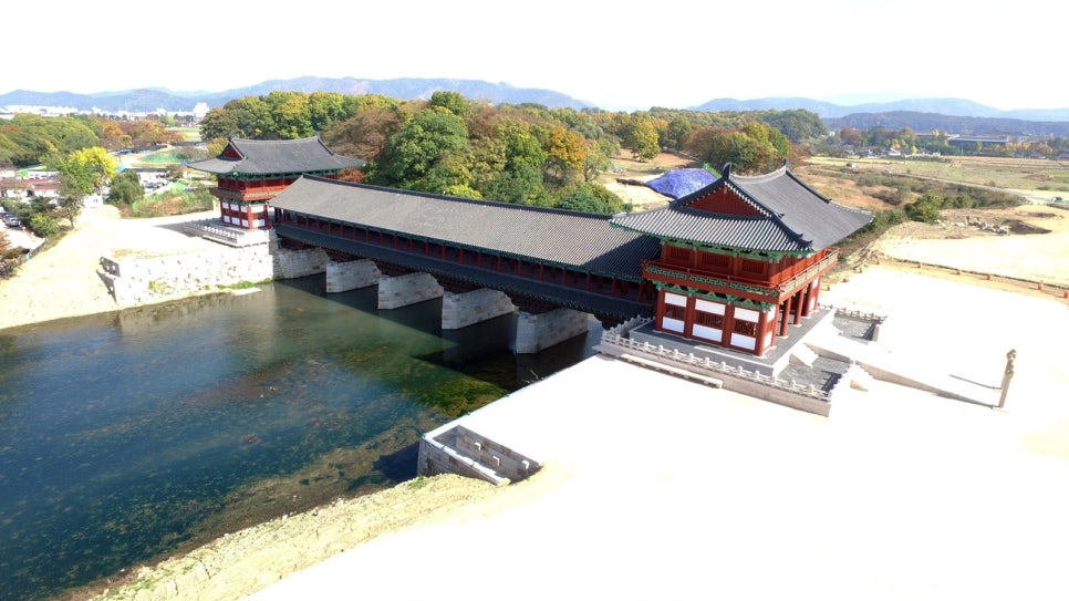An aerial daytime view of the rebuilt Woljeonggyo Bridge and its roofed pavilions spanning the river